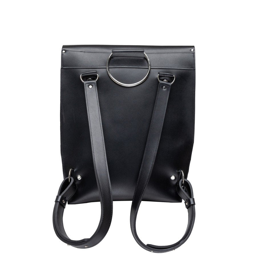 3. Studio shot of PYKOK Backpack Romeo in black leather, showing adjustable shoulder straps and metal ring detail