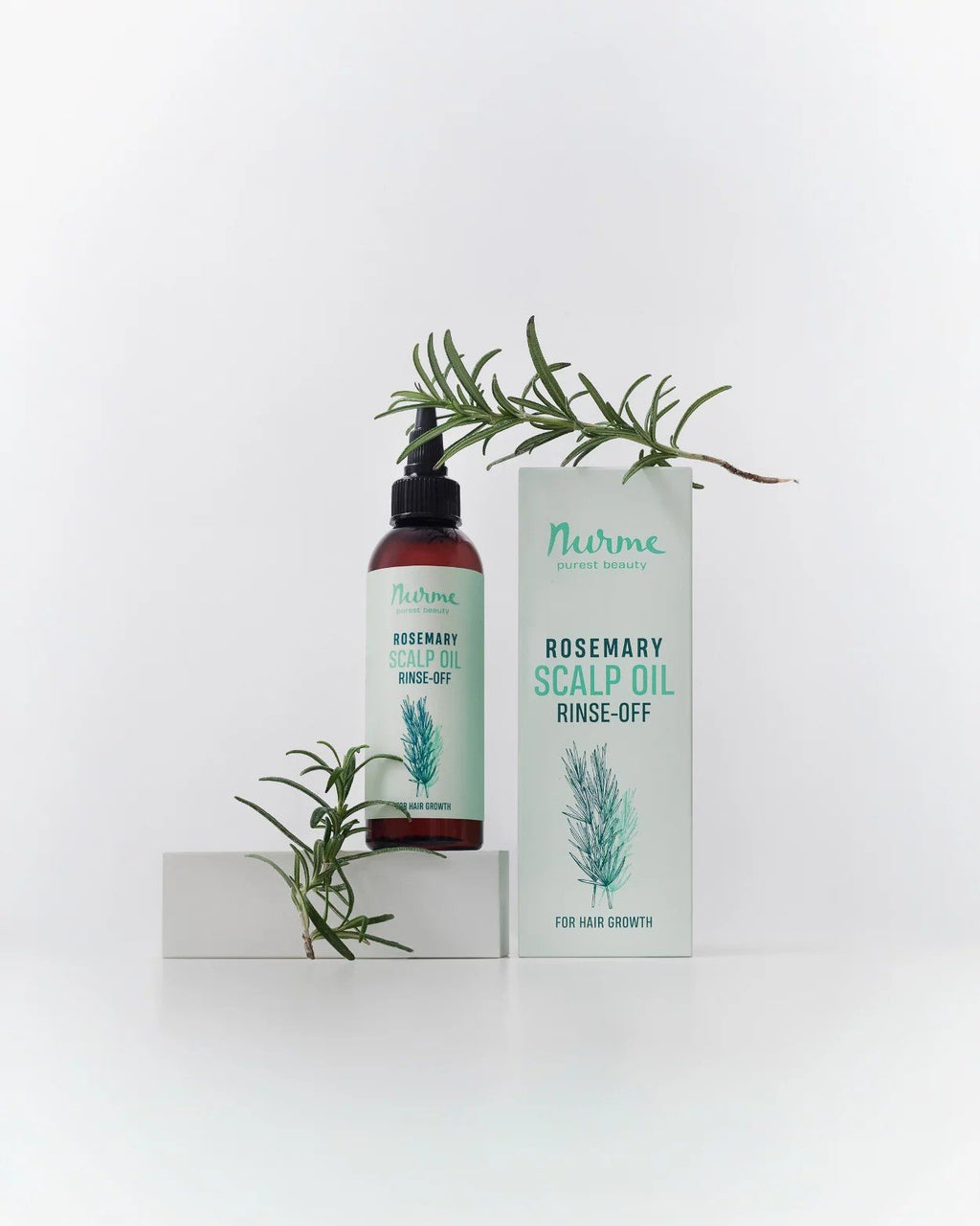 1. Nurme Rosemary Scalp Oil with packaging and rosemary sprigs on white background for natural aesthetic