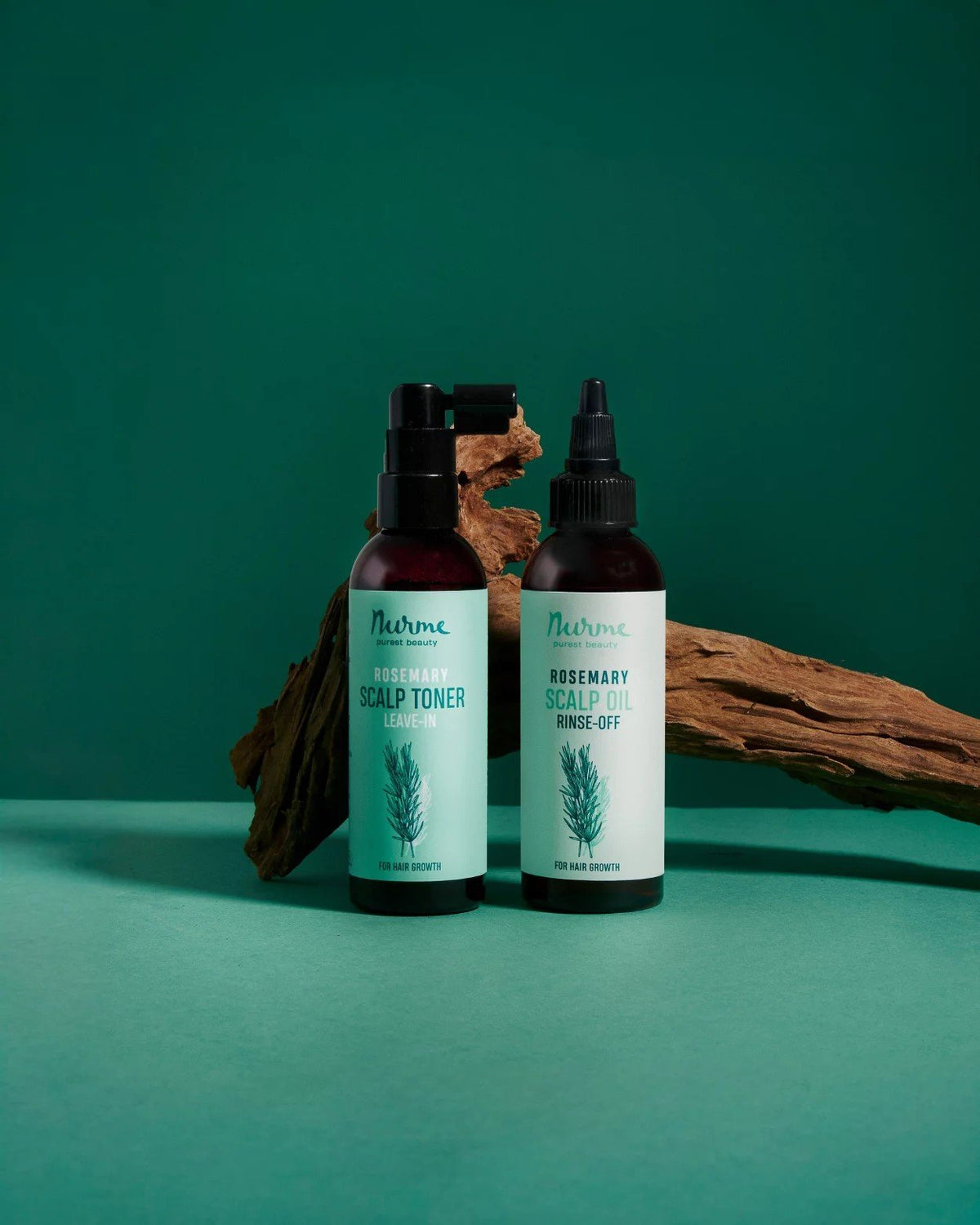 1. Nurme rosemary scalp toner and oil bottles on green background with wooden accents