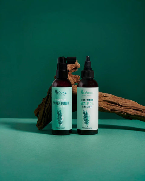 1. Nurme rosemary scalp toner and oil bottles on green background with wooden accents