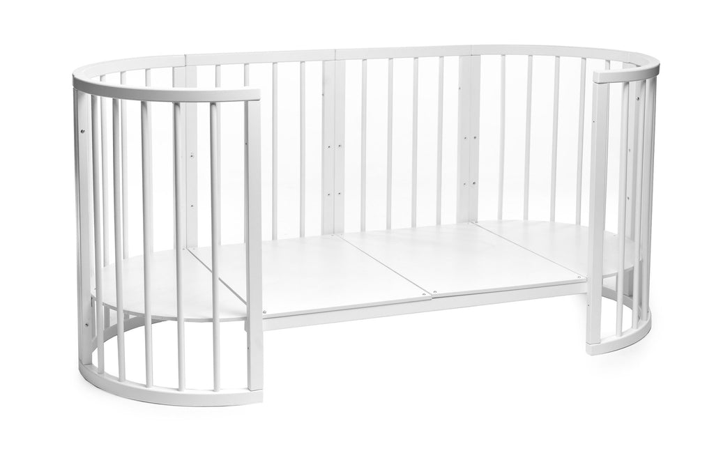 5. White round baby crib converted into an open daybed with side panel removed