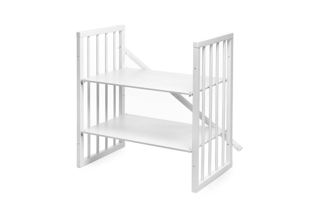 9. Disassembled parts of white round baby crib, showing modular design
