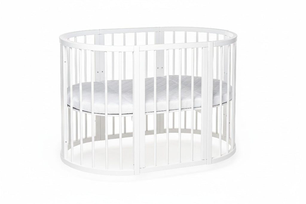 7. White round baby crib with orthopedic slatted base for airflow, shown in a studio
