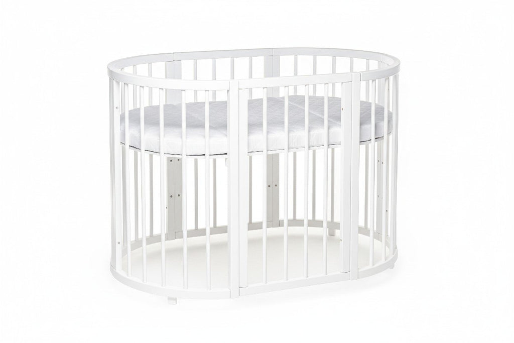 3. White round baby crib with solid beechwood construction, shown with mattress at mid-height