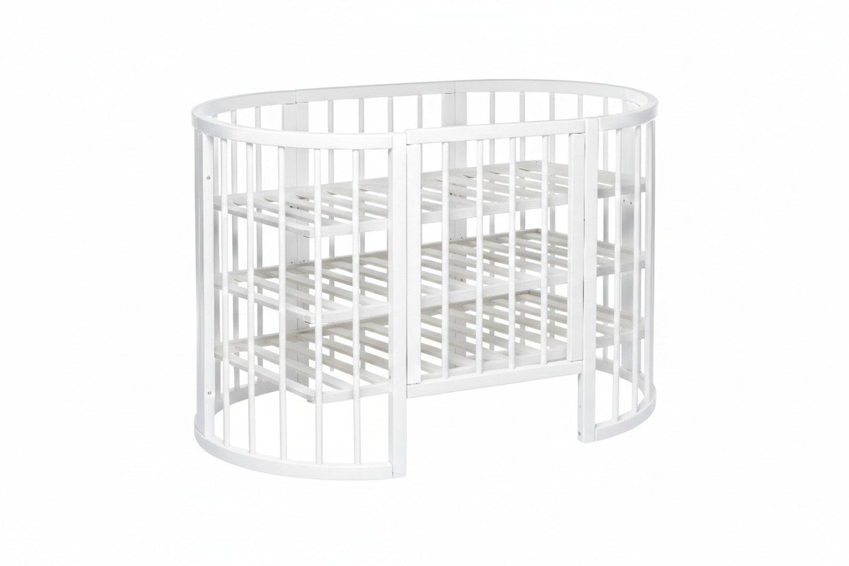 10. White round baby crib with slatted base, shown with mattress removed