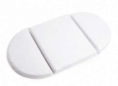 3. Close-up of white transforming mattress for round baby crib, highlighting orthopedic design