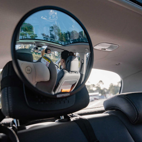 1. Rear view of car interior with Ezimoov mirror showing driver and child