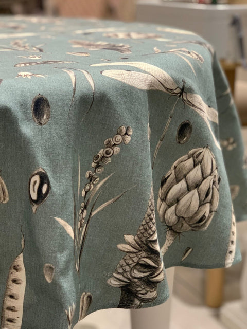 2. Close-up of Seeds Aqua round tablecloth highlighting detailed botanical and insect patterns on teal cotton fabric