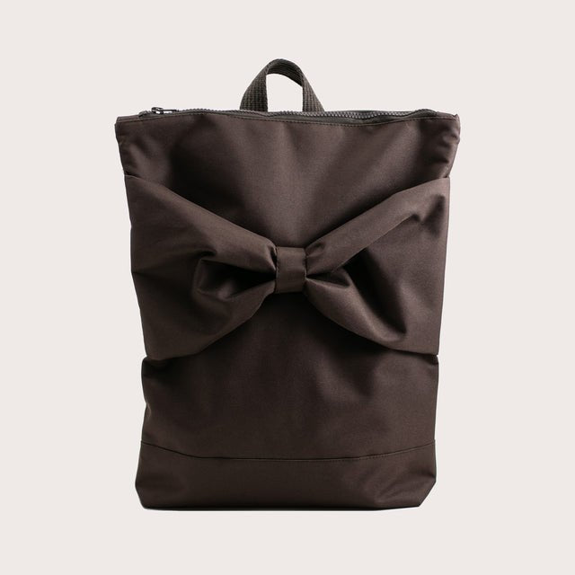 6. Studio image of MUNI waterproof brown backpack with large bow, front view