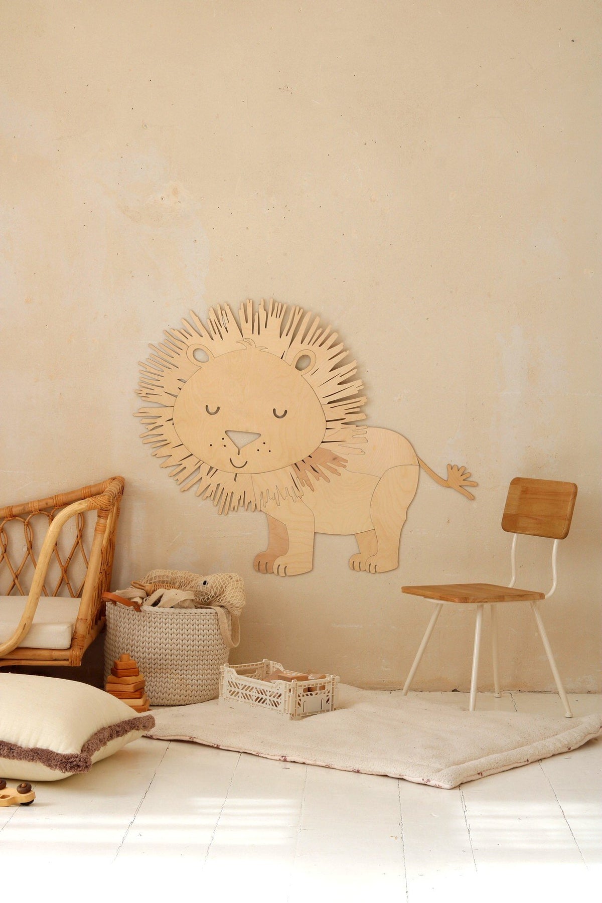 3. Wooden lion wall decoration next to a wooden chair and wicker basket in a light-filled room