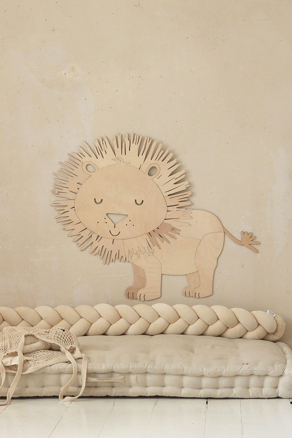1. Wooden lion wall decoration in a cozy room with beige braided cushion and woven basket
