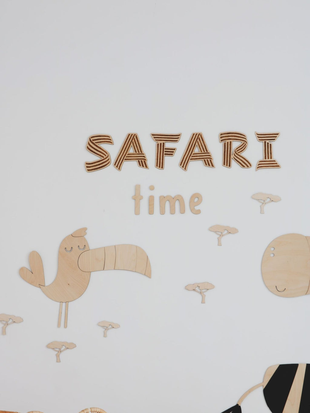 2. Wooden toucan and 'SAFARI time' text wall decoration with mini baobab trees on a white wall