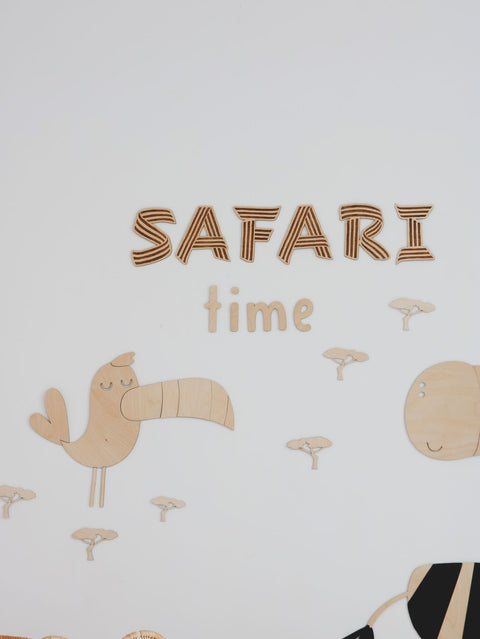 2. Wooden toucan and 'SAFARI time' text wall decoration with mini baobab trees on a white wall