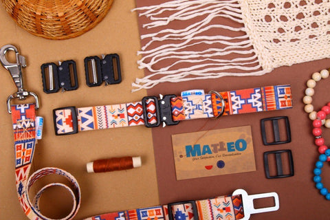 5. Flat lay of Matteo boho safety belt for dogs with colorful pattern, metal clip, and crafting accessories on brown background
