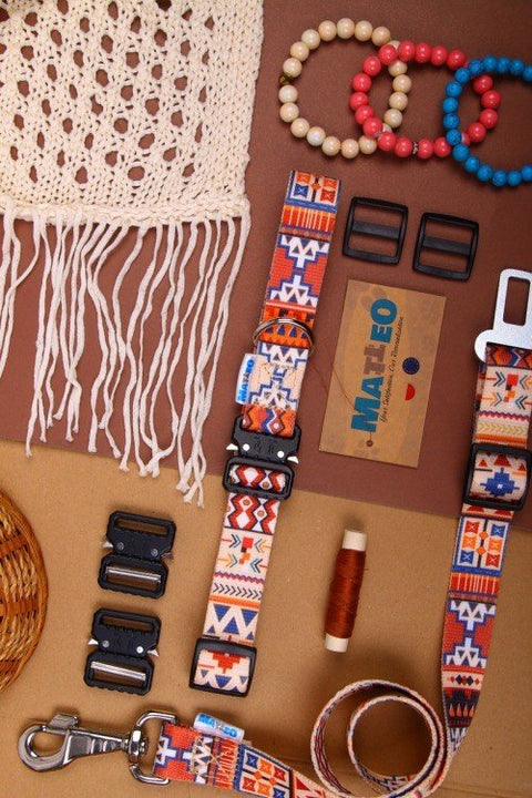 1. Lifestyle flat lay of Matteo boho safety belt for dogs with accessories like beads and crochet fabric on brown background