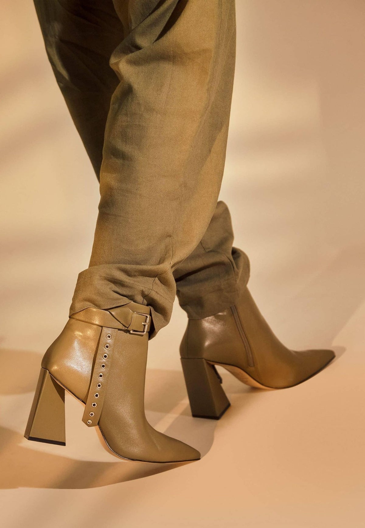 3. Close-up of salvia green leather ankle boots with pointed toe and side buckle detail