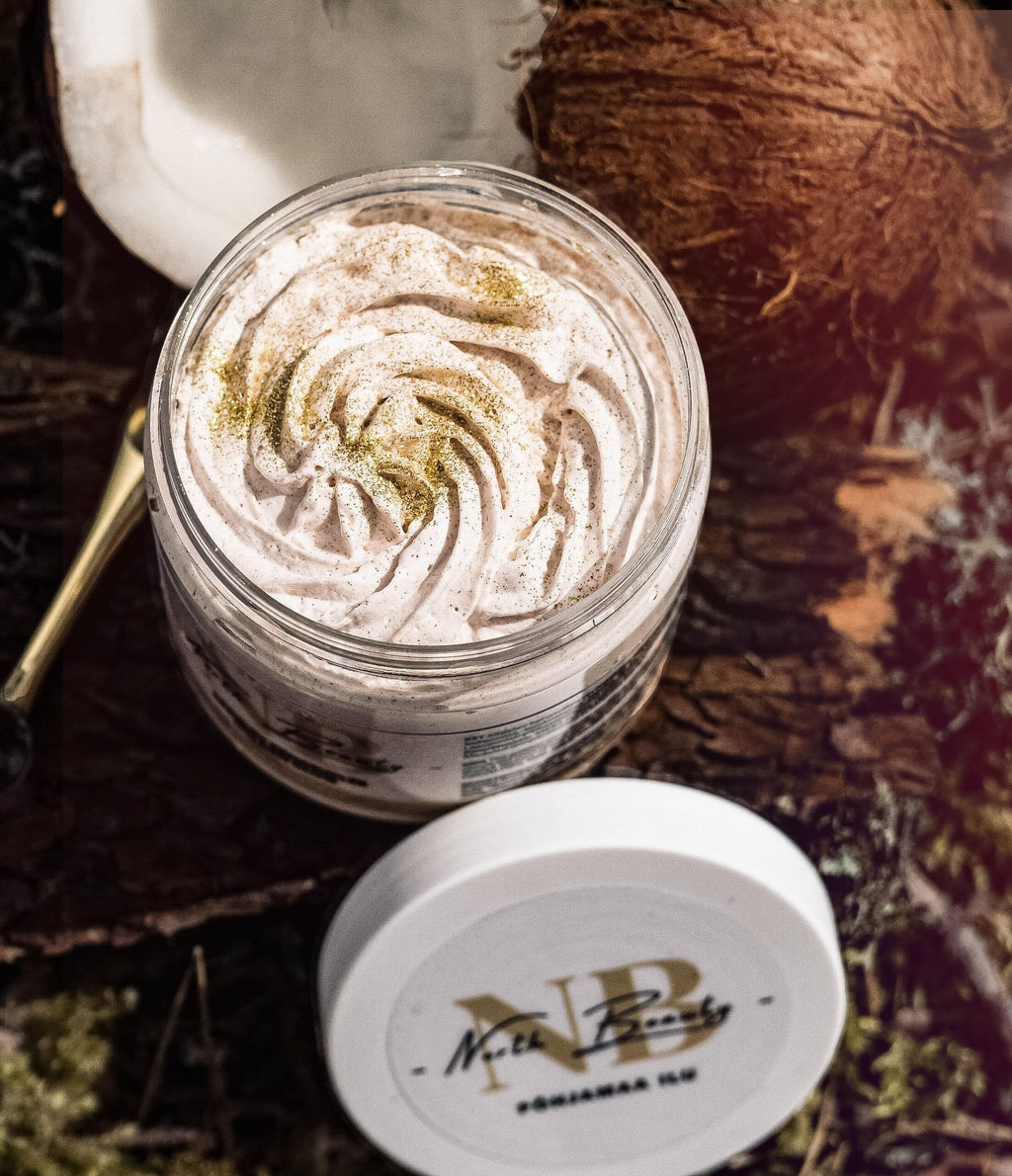 2. North Beauty Golden Glow Body Cream Soufflé in a glass jar with lid off, surrounded by natural elements