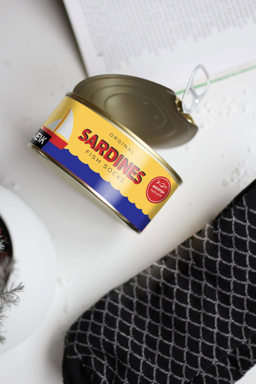 2. SEIK Sardines socks in a playful sardine can packaging, open lid revealing unique design