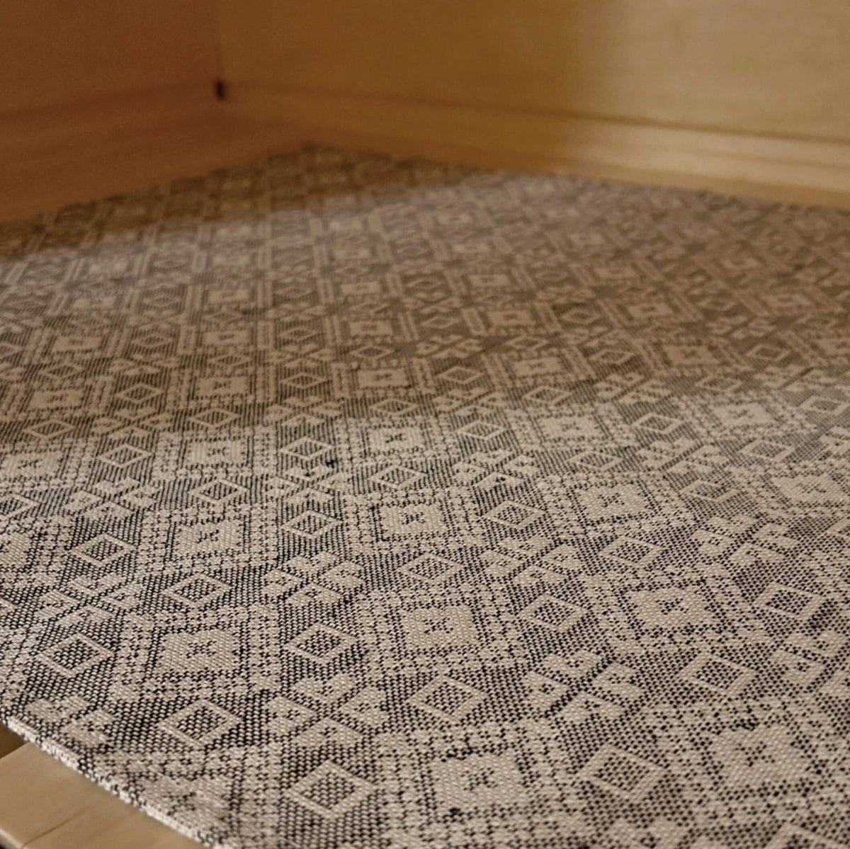 3. Close-up of Tartu County mitten pattern on LOKO sauna seating pad in linen-cotton fabric