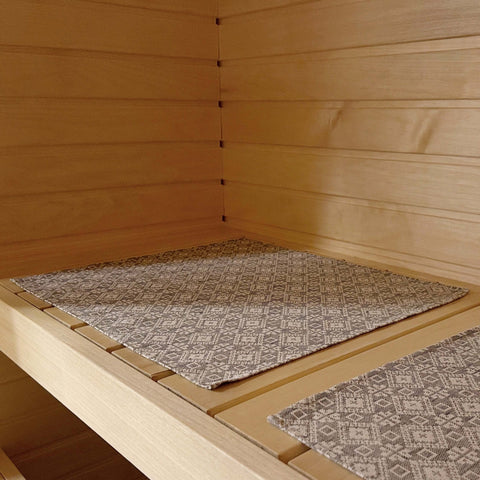 2. LOKO sauna seating pad on wooden bench showcasing traditional Tartu County design