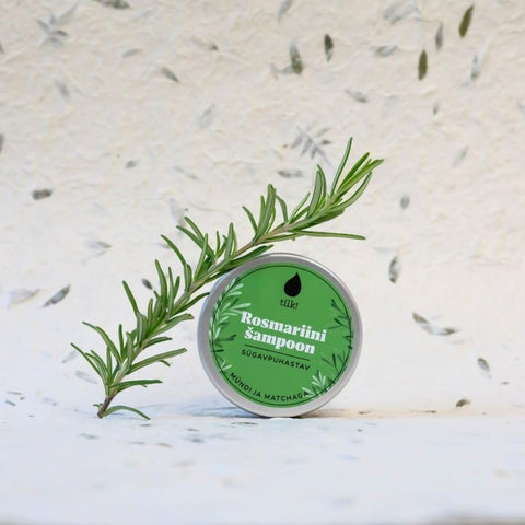 2. Tilk! Deep-Cleansing Solid Matcha Shampoo tin with rosemary sprig, highlighting natural ingredients