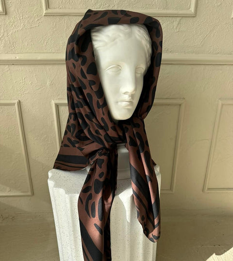 4. Studio shot of Garbanota Classic Leopard Scarf draped over a bust, highlighting silky texture and leopard print