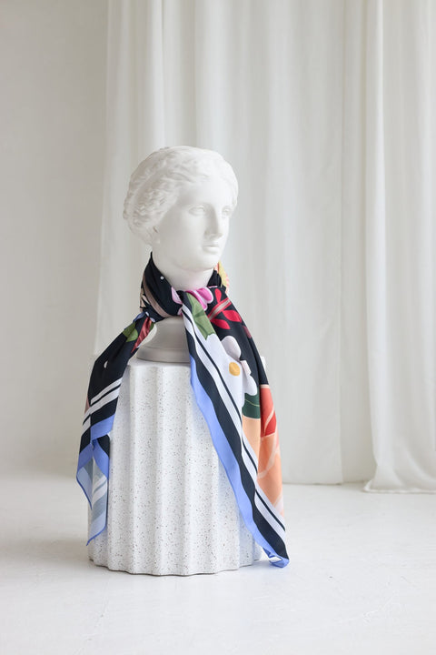 4. Garbanota Scarf Curly Summer Night tied around a mannequin neck, highlighting design