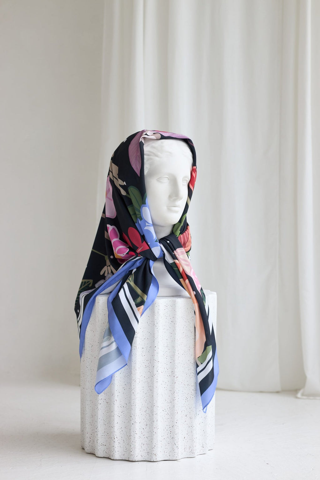 3. Garbanota Scarf Curly Summer Night styled on a mannequin head, showcasing floral print