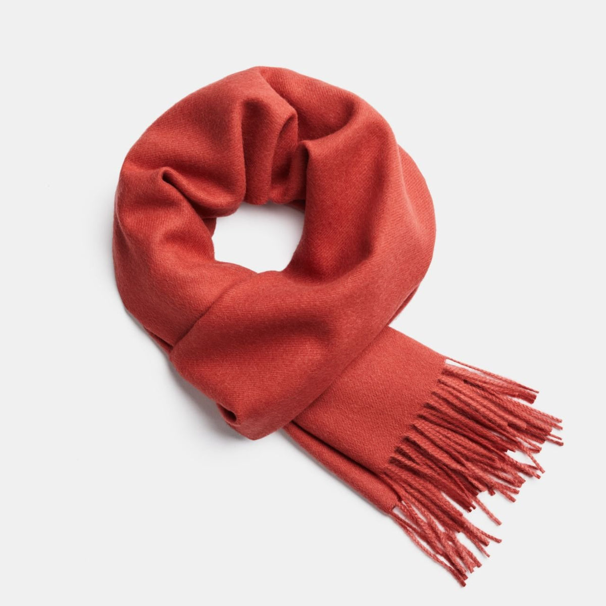 7. Red Alpaka baby alpaca wool scarf with fringe detail in flat lay