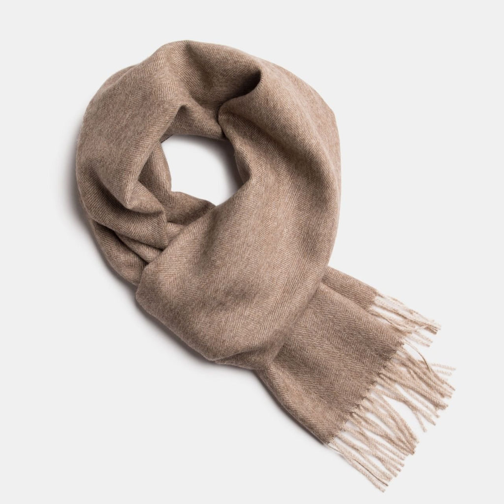 12. Studio image of Alpaka natural baby alpaca wool scarf in beige with fringe detail