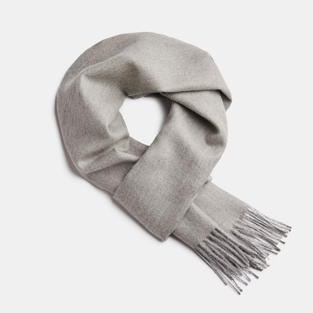 22. Studio image of Alpaka natural baby alpaca wool scarf in light grey with fringe detail