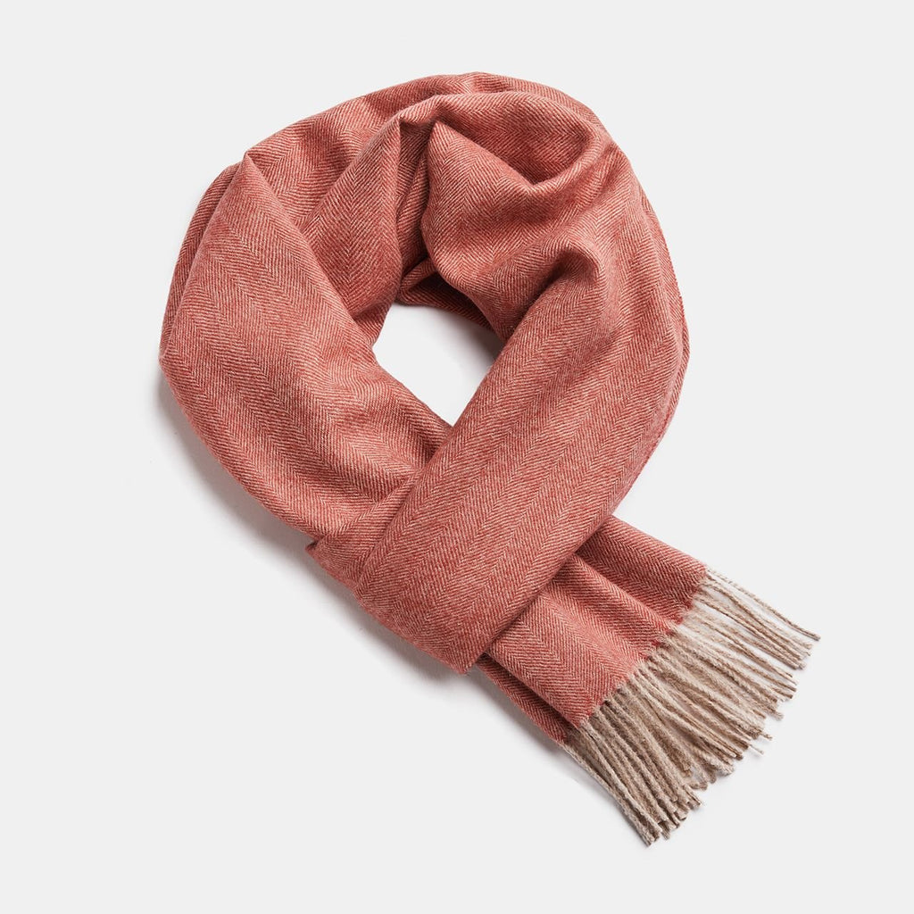 3. Studio image of Alpaka natural baby alpaca wool scarf in coral with fringe detail