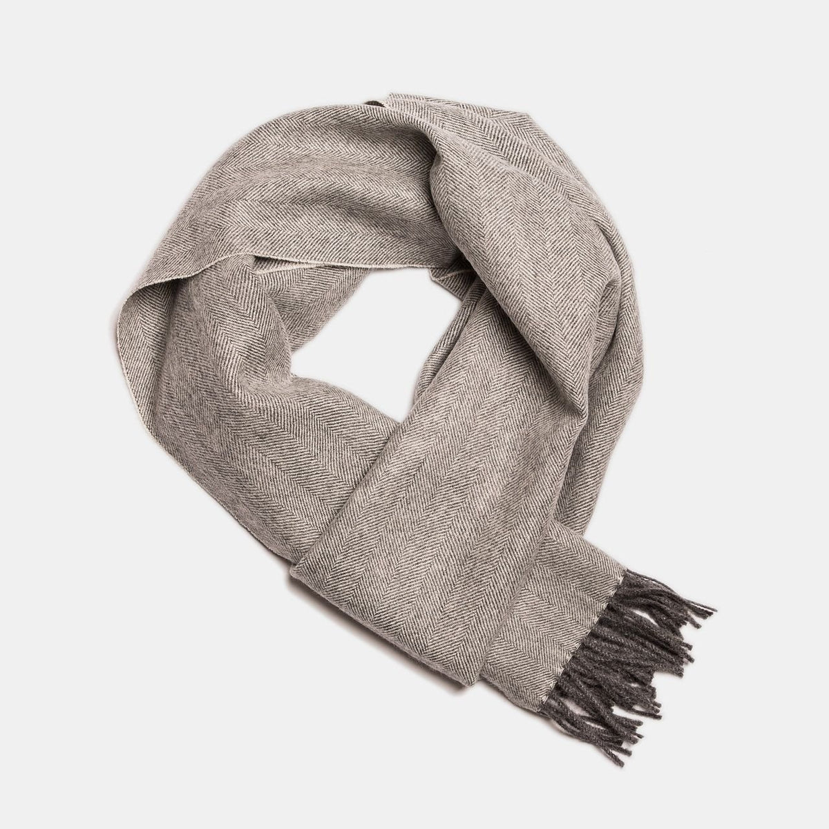 23. Studio image of Alpaka natural baby alpaca wool scarf in taupe with fringe detail