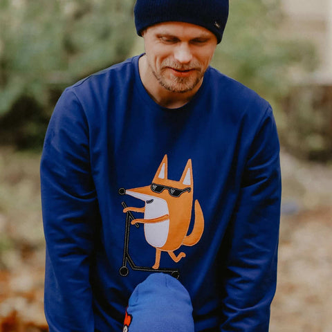 1. Men's Scootering Fox Sweatshirt in navy blue worn by male model outdoors, featuring playful fox graphic