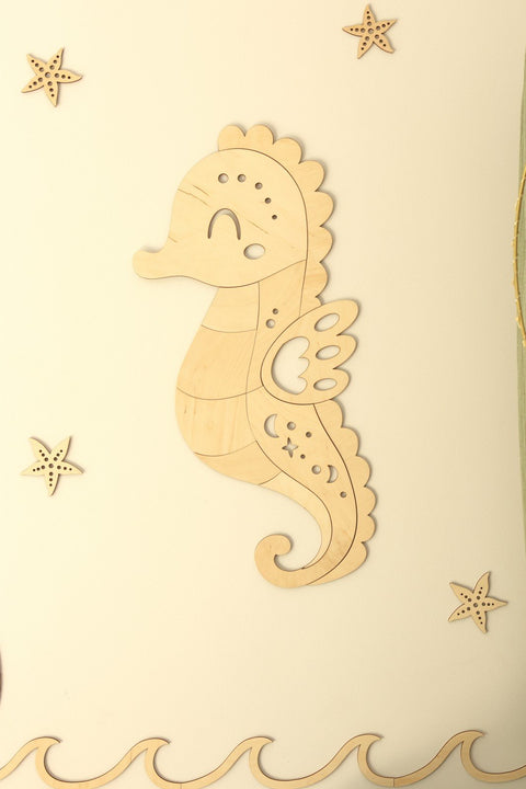 4. Wooden seahorse wall decoration in natural plywood with starfish accents on a light wall