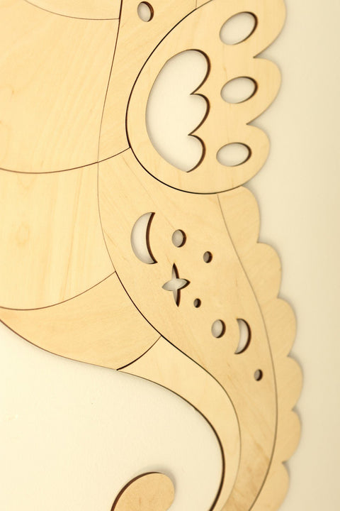 3. Close-up of wooden seahorse wall decoration showing detailed cutouts in natural plywood