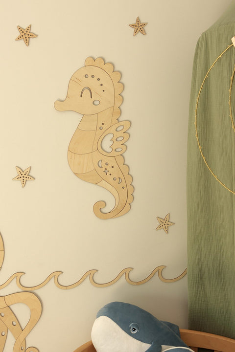 1. Wooden seahorse wall decoration in natural plywood with starfish accents on a nursery wall
