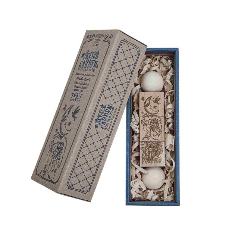 4. Flat lay of Secret Garden wooden spinning puzzle in eco-friendly packaging with intricate designs