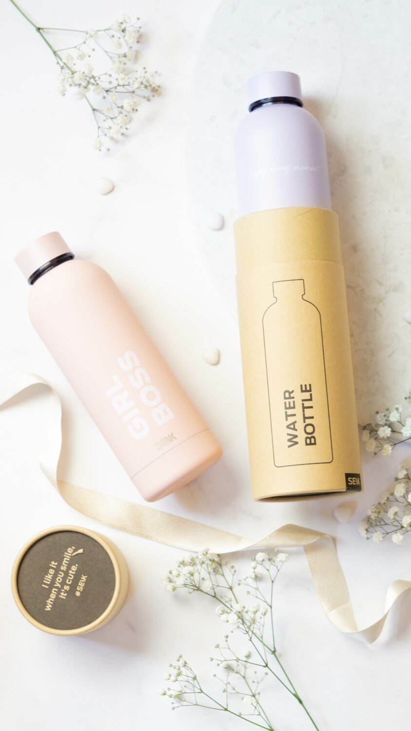 1. SEIK lilac water bottle and thermos with 'Enjoy Every Moment' text, shown with packaging and floral accents