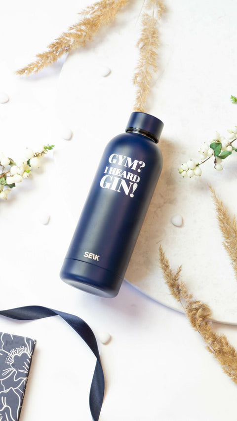 2. SEIK dark blue stainless steel water bottle with motivational slogan, styled with natural elements