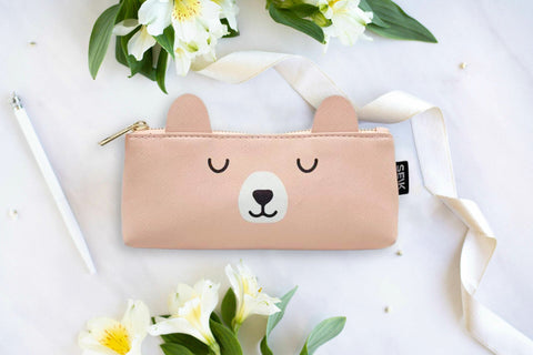 1. SEIK pastel orange pencil case with adorable bear design, shown in a lifestyle setting with flowers and ribbon