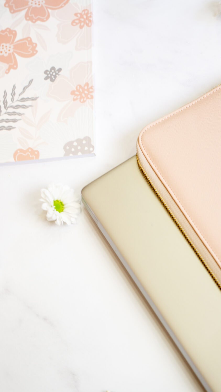 10. SEIK pink laptop sleeve next to a laptop, with floral and ribbon decor