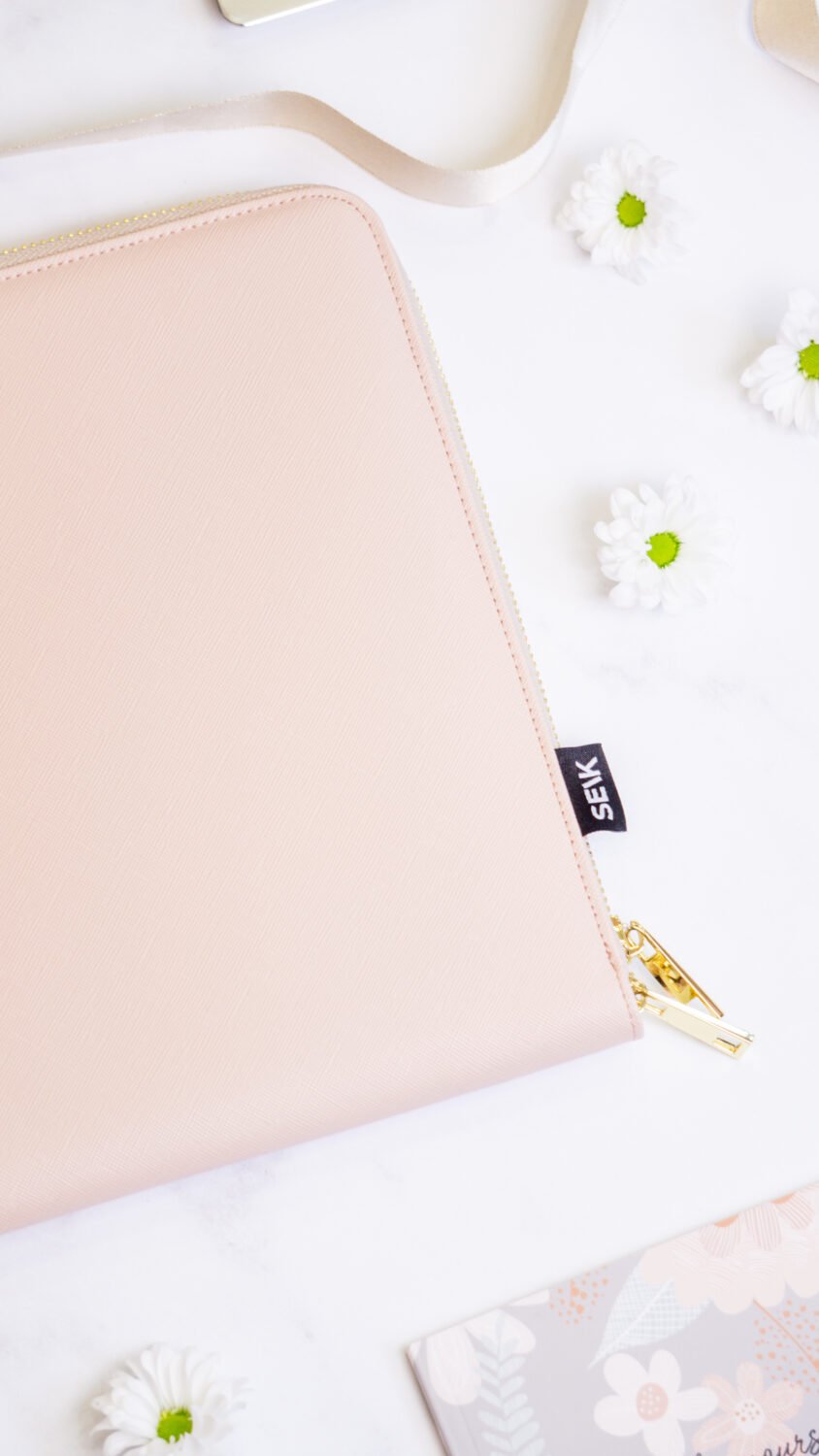 5. SEIK pink laptop sleeve with brand tag and gold zipper detail