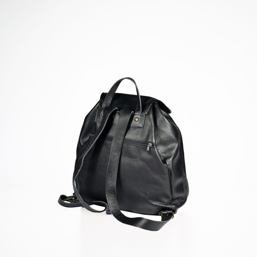 2. Back view of Papillon black leather backpack with adjustable shoulder straps, studio setting