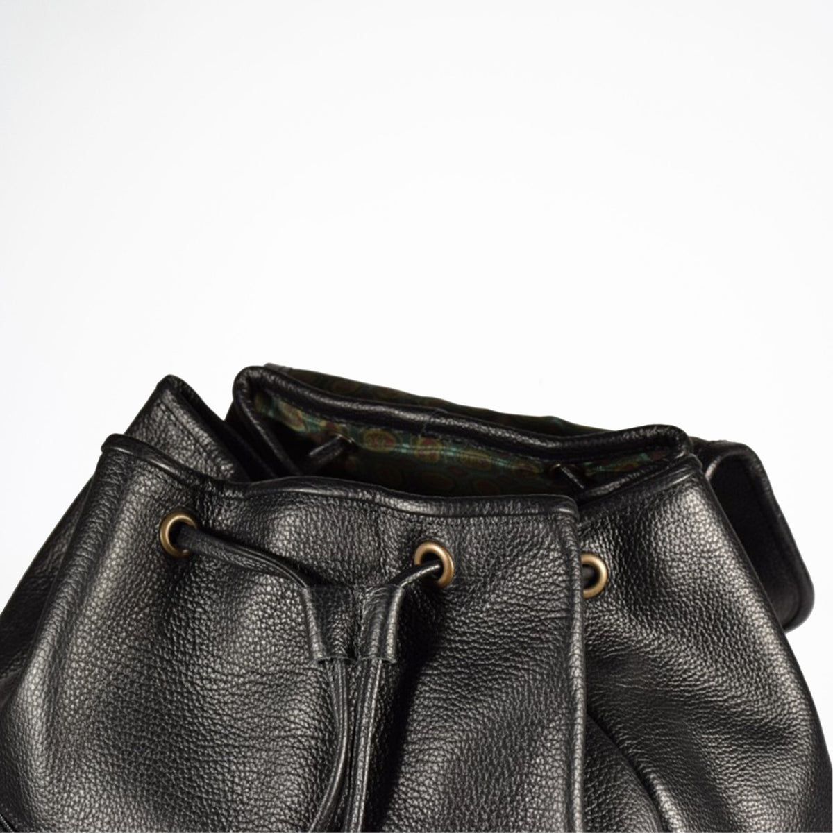 3. Close-up of Papillon black leather backpack showing interior and drawstring closure