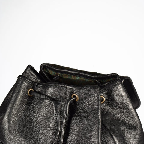 3. Close-up of Papillon black leather backpack showing interior and drawstring closure