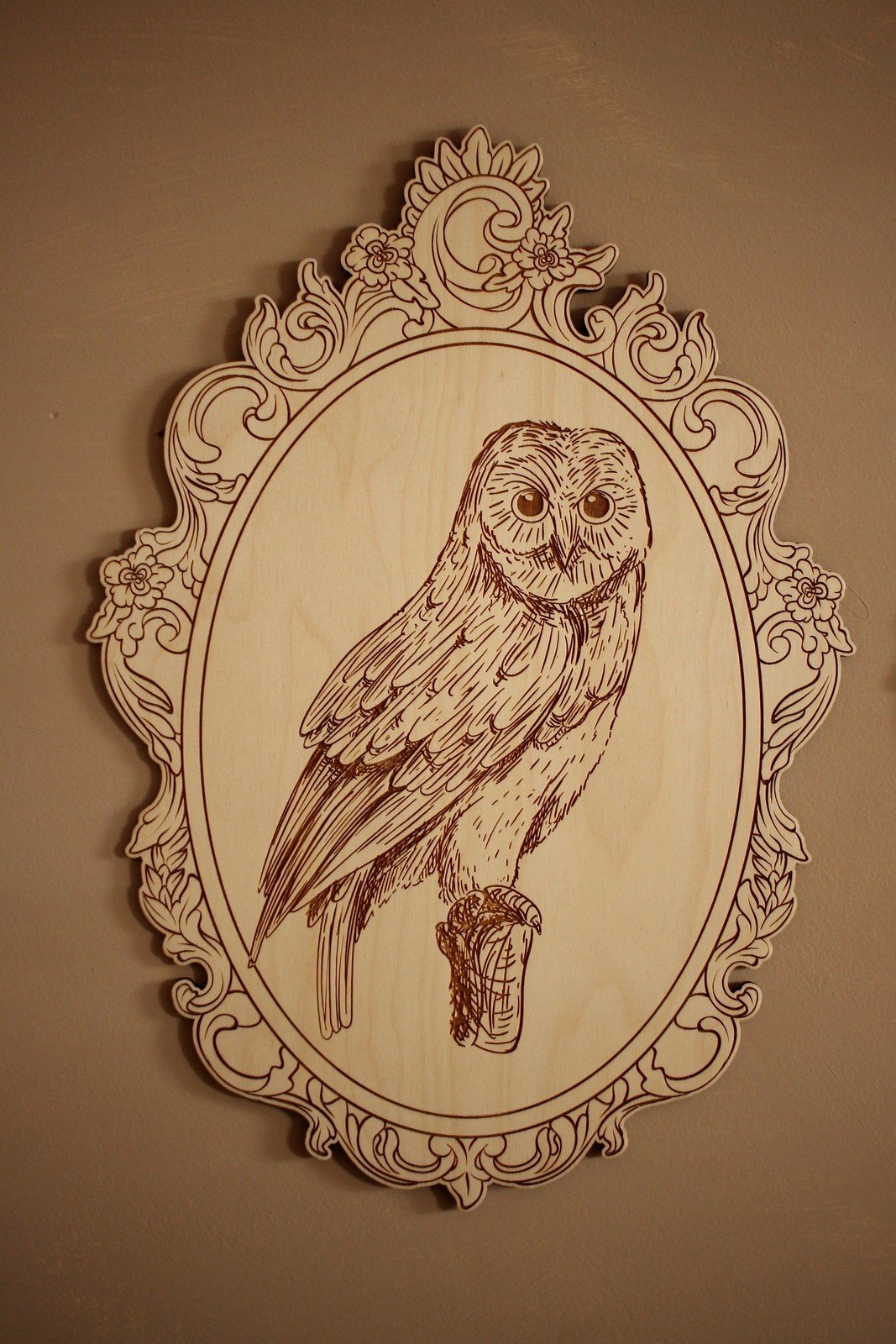 6. Close-up of engraved owl picture in ornate retro frame on wall