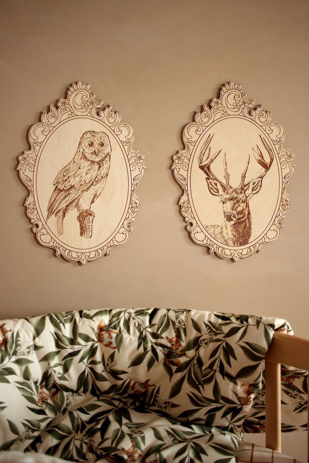 1. Engraved owl and deer pictures in retro frames on wall above floral-patterned couch