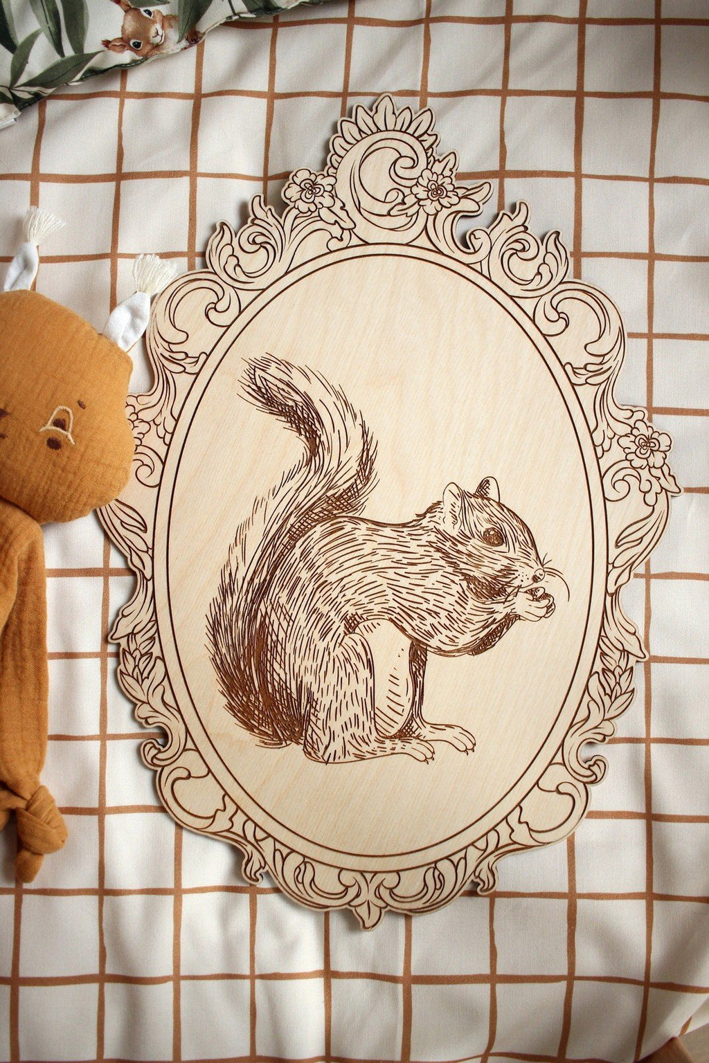4. Engraved squirrel picture in retro frame on checkered fabric with plush toy