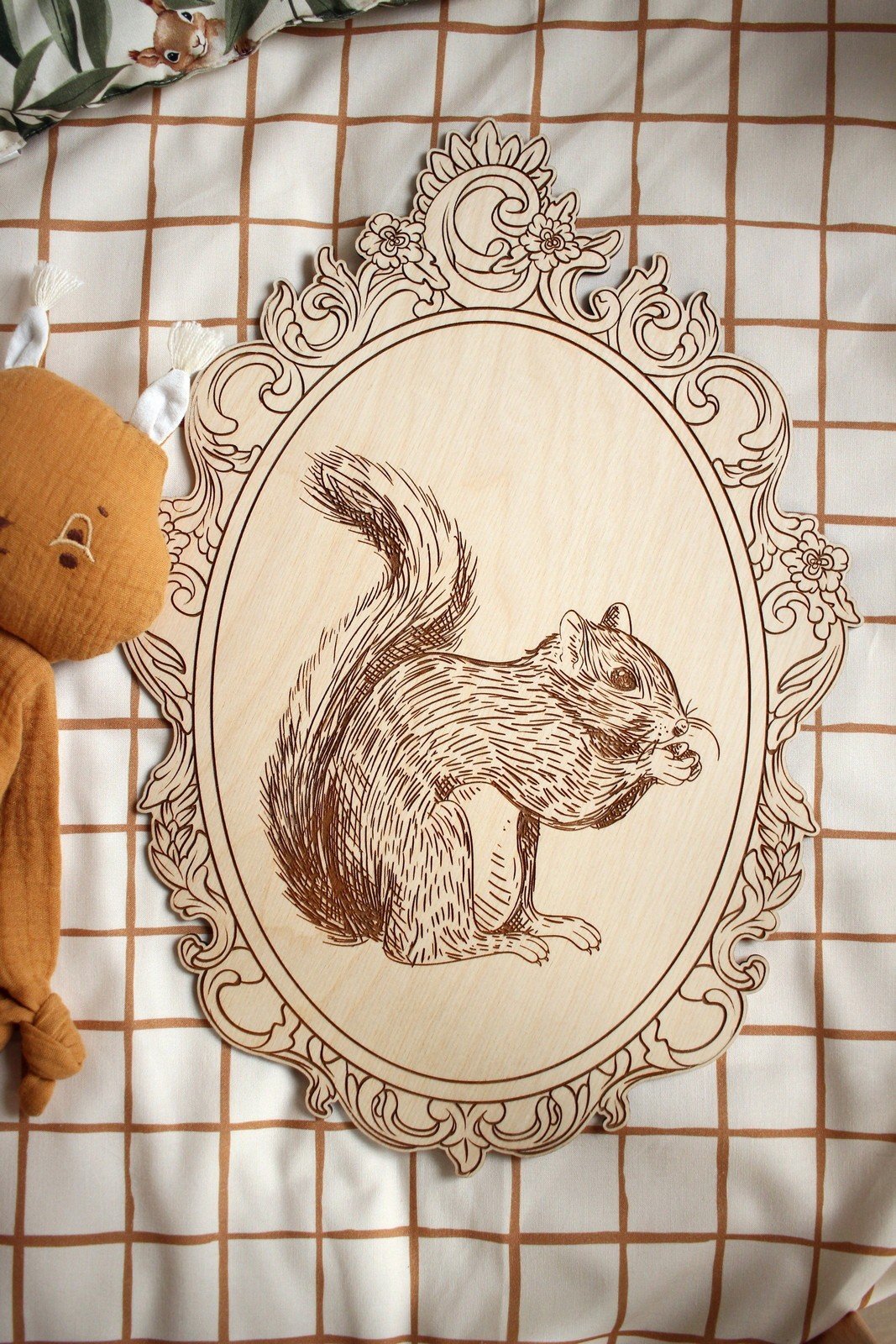4. Engraved squirrel picture in retro frame on checkered fabric with plush toy
